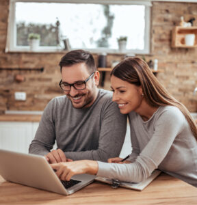 young spouses sitting table their homely apartment looking laptop 1