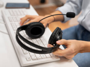 woman working call center holding pair headphones 1 1