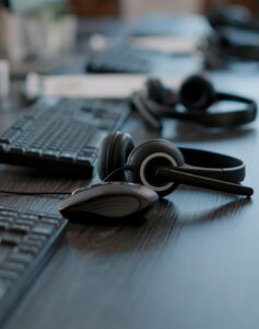 audio headset used by call center agents help clients telecommunication with technology empty customer service workstation with headphones computers modern gadgets 1